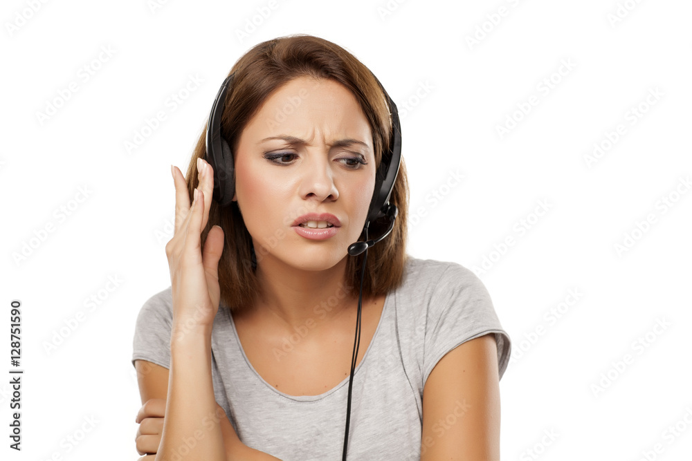 unhappy young woman with headset on her head unhappy young woman with headset on her head