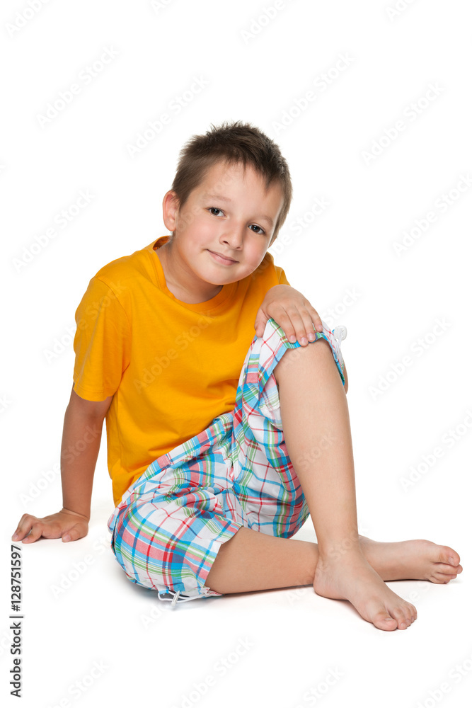 Little boy in the yellow shirt sits Little boy in the yellow shirt sits
