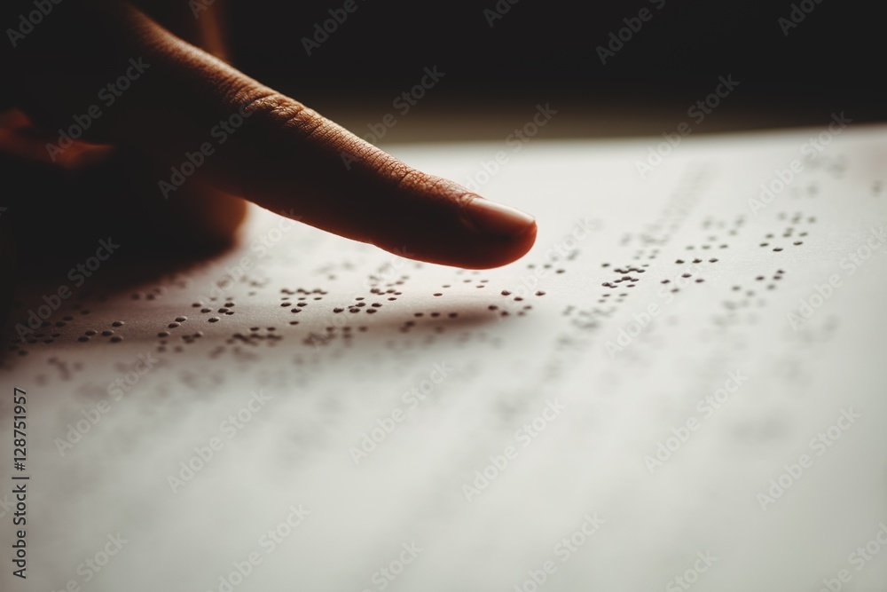 Obraz premium A person reading braille 