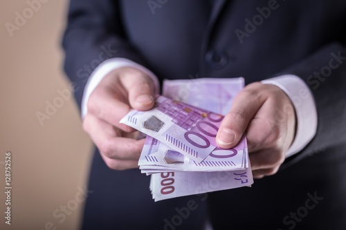 Bribe and corruption with euro banknotes. photo