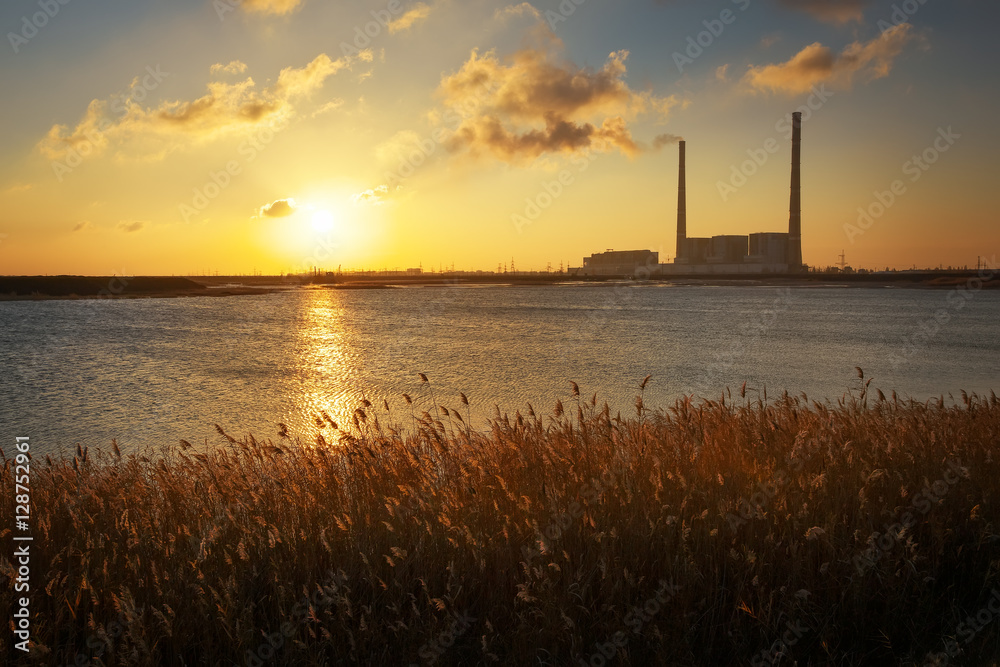 Beautifull landscape with thermal power plant, lake and sunset 