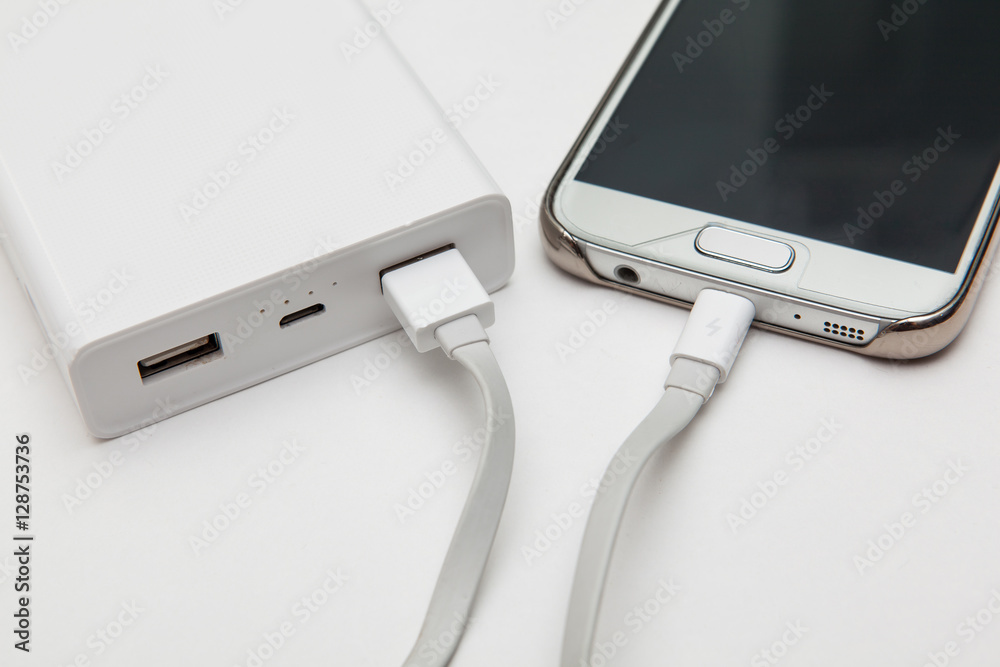 charging smart phone with portable battery on white backgrounds charging smart phone with portable battery on white backgrounds