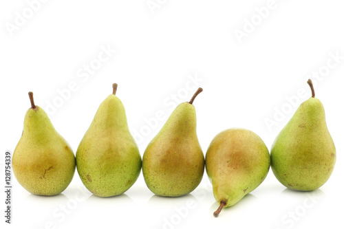 row of fresh migo pears on a white background