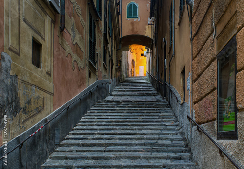 ascending stone stairs along the street Salita Di Negro with a small archway in Genoa, Italy © NRoytman Photography