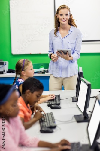 Teacher giving lesson to her students with technology