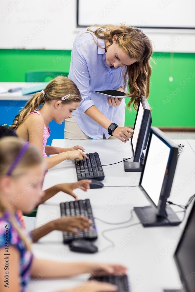 Teacher giving lesson to her students with technology Teacher giving lesson to her students with technology