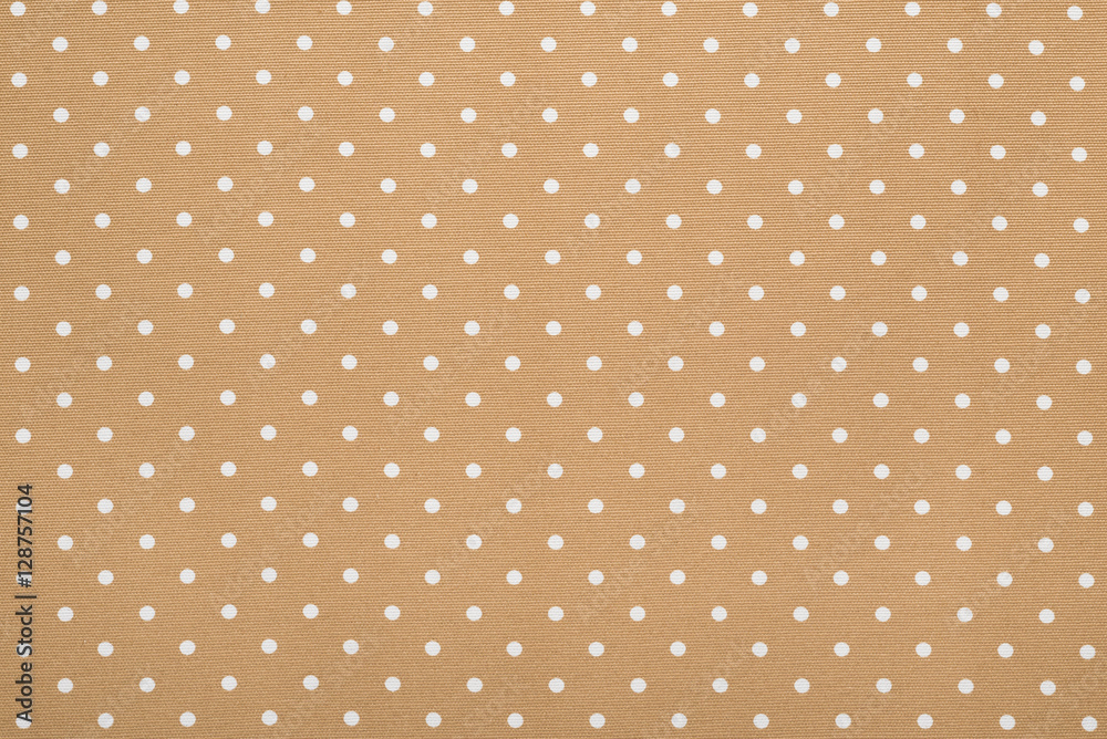 Beige background of dots textile texture
