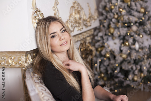The pretty girl next to the fireplace and Christmas tree © viktoria_koks