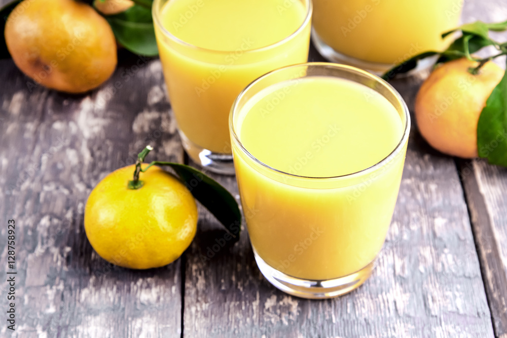 Fresh juice of ripe mandarins in a small glass Fresh juice of ripe mandarins in a small glass