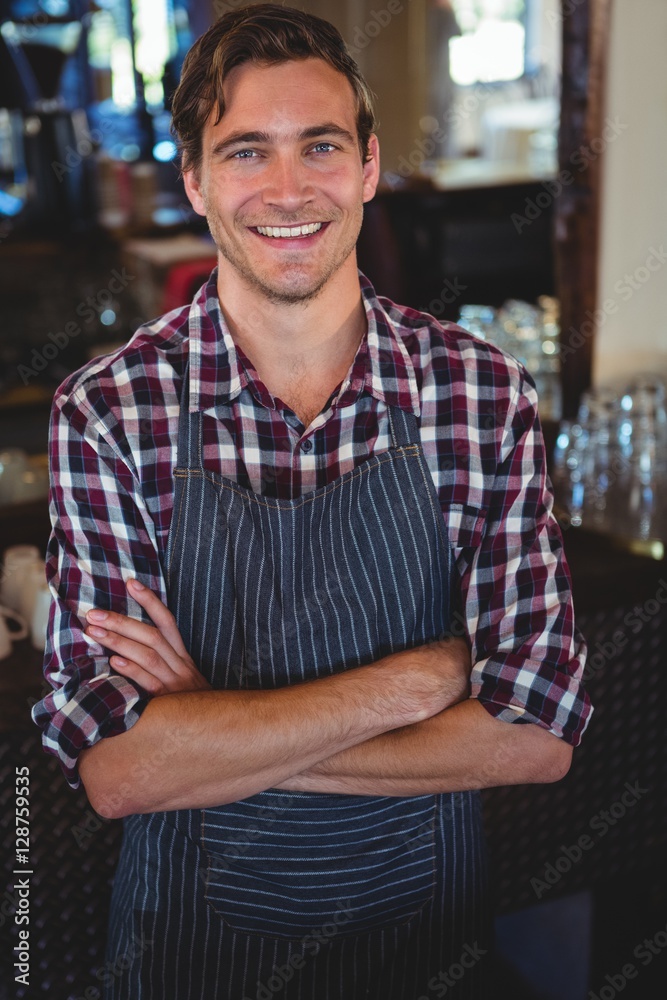 Obraz premium Smiling waiter with arms crossed