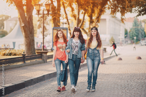 three young girls walking in the park