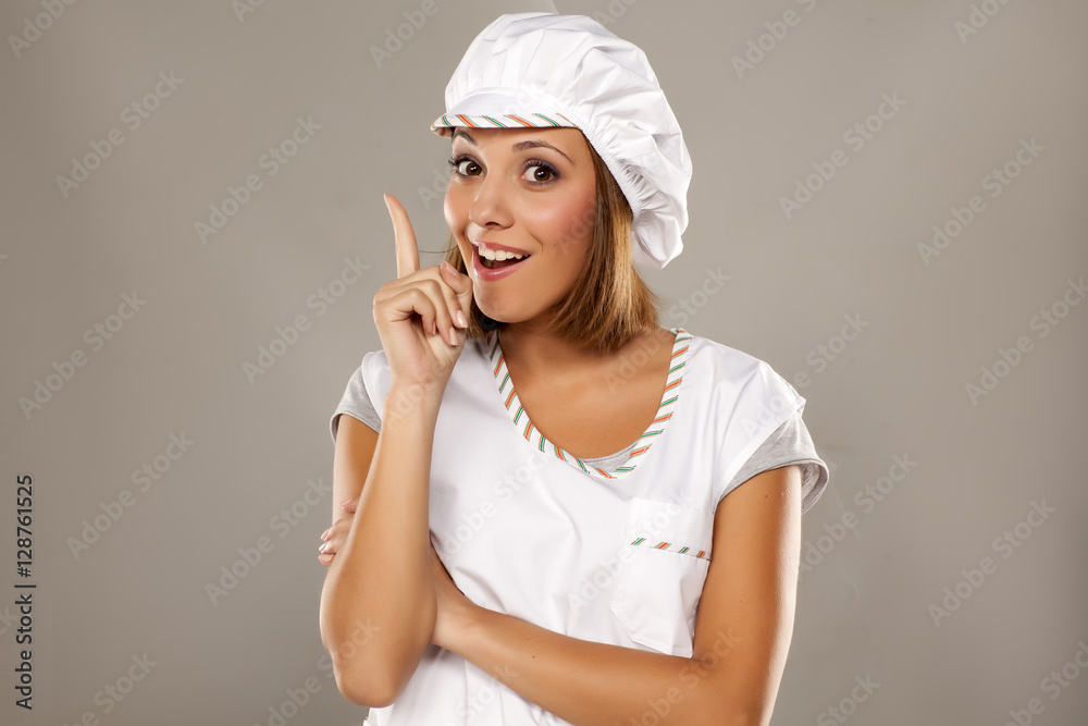 young beautiful woman posing with a chef's apron and cap young beautiful woman posing with a chef's apron and cap