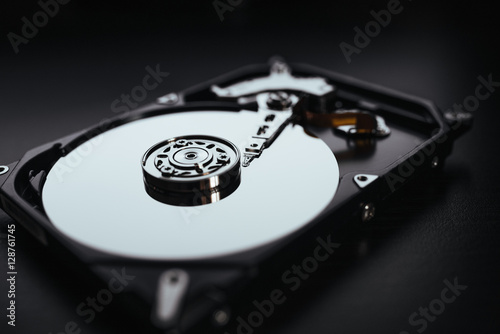 Disassembled hard drive from the computer, hdd with mirror effect. Opened hard drive from the computer hdd with mirror effects. Part of computer pc, laptop