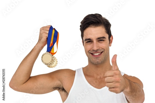 Athlete posing with gold medals