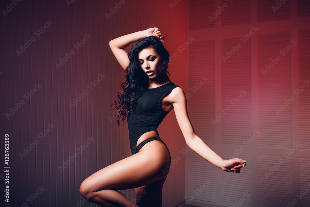 Fototapeta premium Perfect, sexy body, legs and ass of young woman wearing seductive lingerie shows her erotical torso, posing in a sensual way