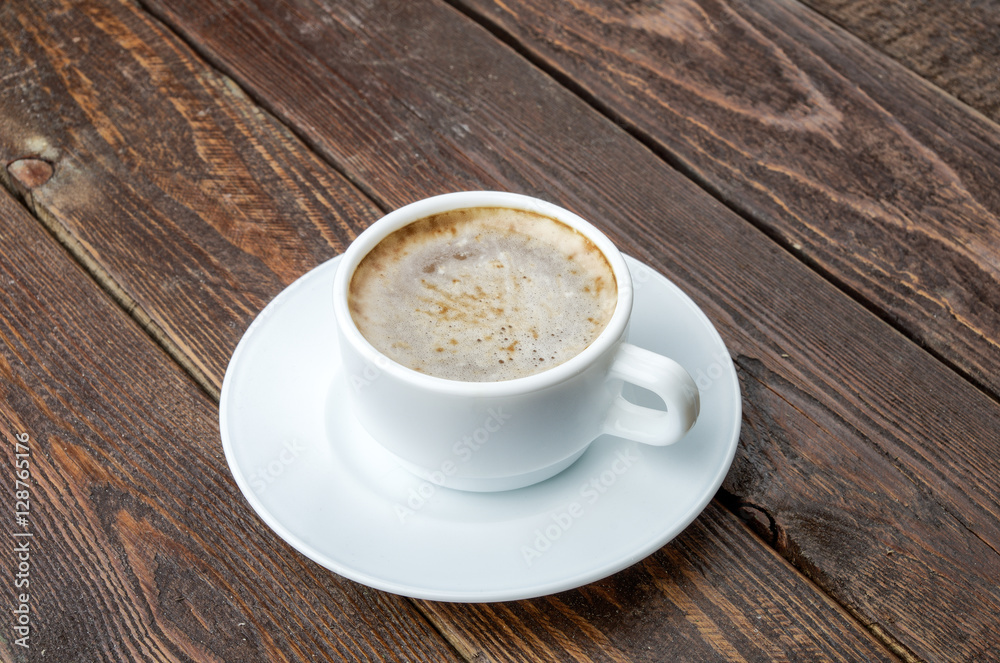 Coffee with foam on dark wood table Coffee with foam on dark wood table