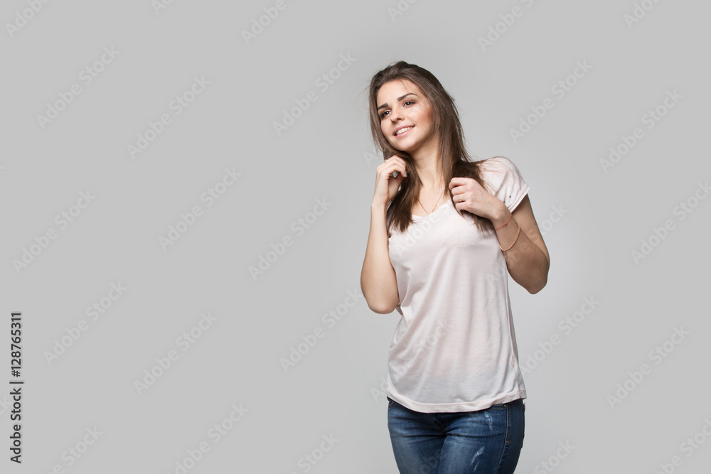 Portrait of beautiful brunette woman with natural make-up, on grey background Portrait of beautiful brunette woman with natural make-up, on grey background