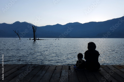 Silhouette mother and child watching the natural scenery.copy space