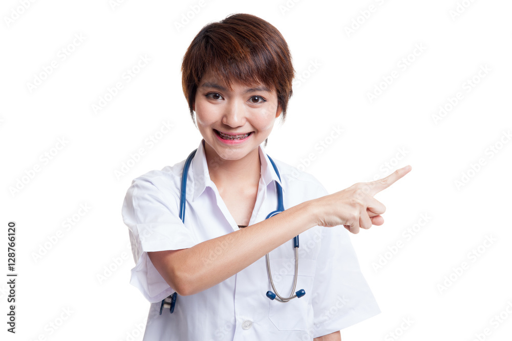 Asian young female doctor point to blank space. Asian young female doctor point to blank space.