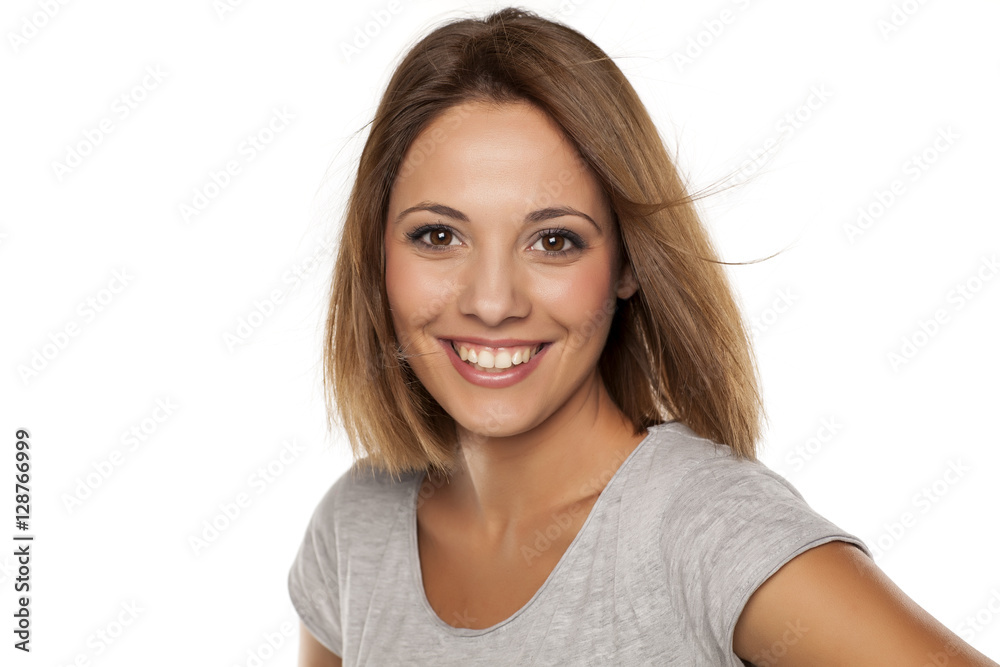 happy young woman posing with wind in her hair happy young woman posing with wind in her hair