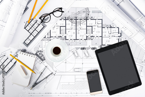 Construction plans with Tablet, smartphone and drawing Tools on