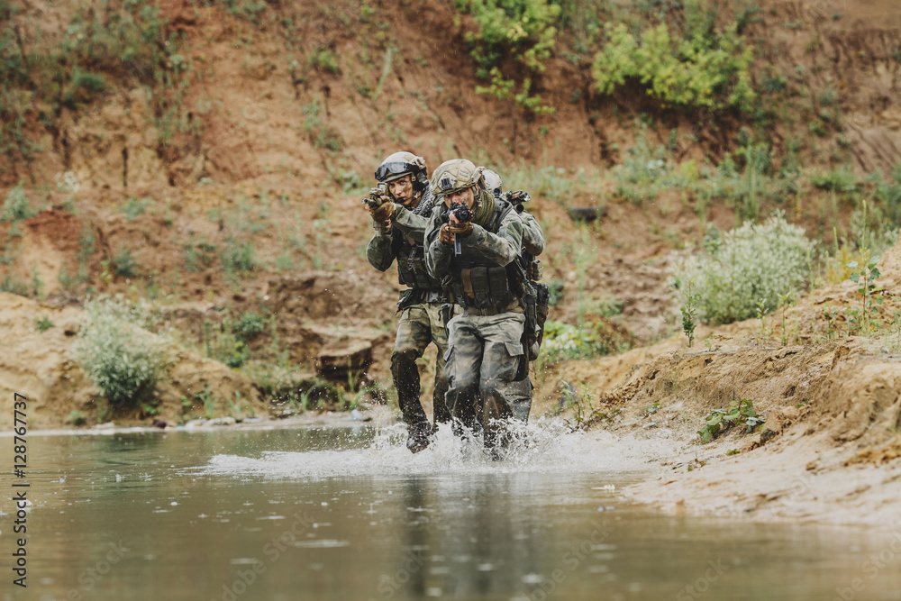 Military team crossing the river under fire Military team crossing the river under fire