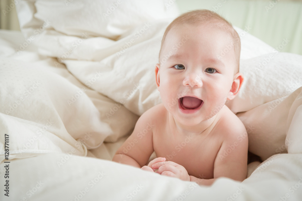Young Mixed Race Chinese and Caucasian Baby Boy Having Fun on His Blanket. Young Mixed Race Chinese and Caucasian Baby Boy Having Fun on His Blanket.