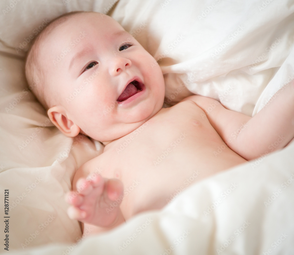 Young Mixed Race Chinese and Caucasian Baby Boy Having Fun on His Blanket. Young Mixed Race Chinese and Caucasian Baby Boy Having Fun on His Blanket.