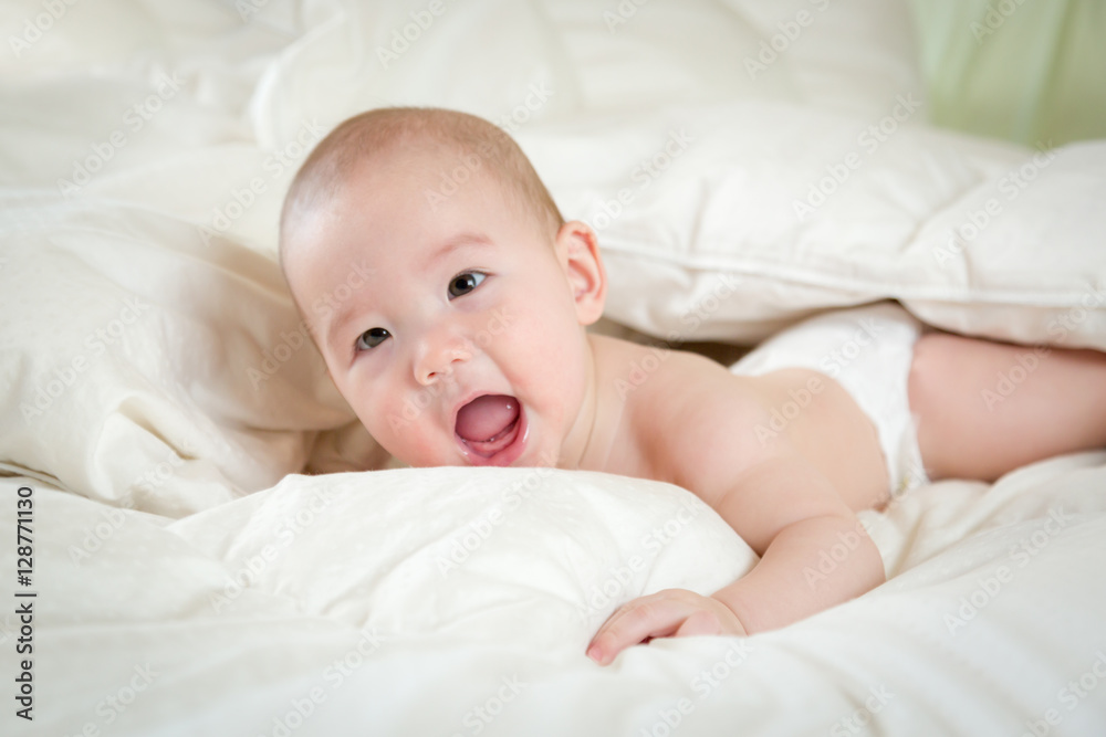 Young Mixed Race Chinese and Caucasian Baby Boy Having Fun on His Blanket. Young Mixed Race Chinese and Caucasian Baby Boy Having Fun on His Blanket.