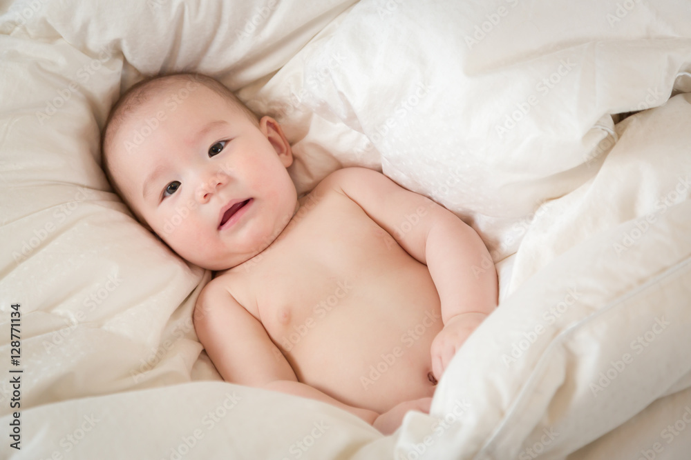 Young Mixed Race Chinese and Caucasian Baby Boy Having Fun on His Blanket. Young Mixed Race Chinese and Caucasian Baby Boy Having Fun on His Blanket.