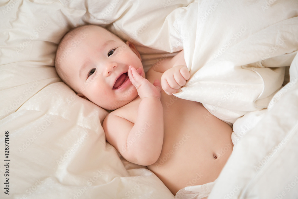 Young Mixed Race Chinese and Caucasian Baby Boy Having Fun on His Blanket. Young Mixed Race Chinese and Caucasian Baby Boy Having Fun on His Blanket.