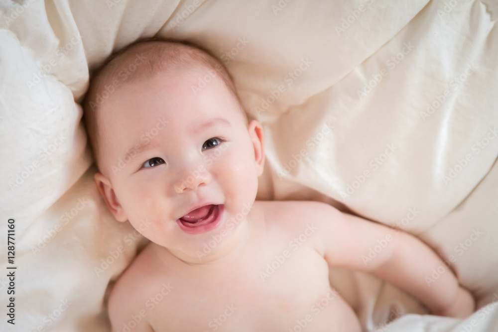 Young Mixed Race Chinese and Caucasian Baby Boy Having Fun on His Blanket. Young Mixed Race Chinese and Caucasian Baby Boy Having Fun on His Blanket.