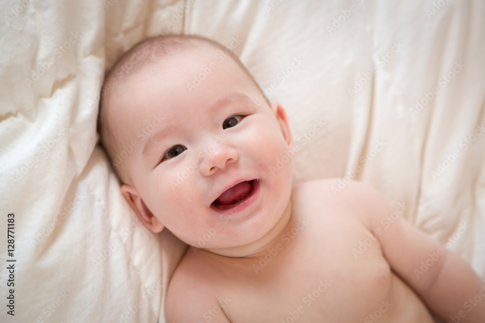 Young Mixed Race Chinese and Caucasian Baby Boy Having Fun on His Blanket. Young Mixed Race Chinese and Caucasian Baby Boy Having Fun on His Blanket.