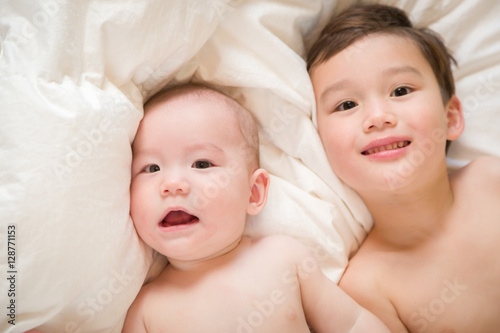 Young Mixed Race Chinese and Caucasian Baby Brothers Having Fun on Their Blanket.