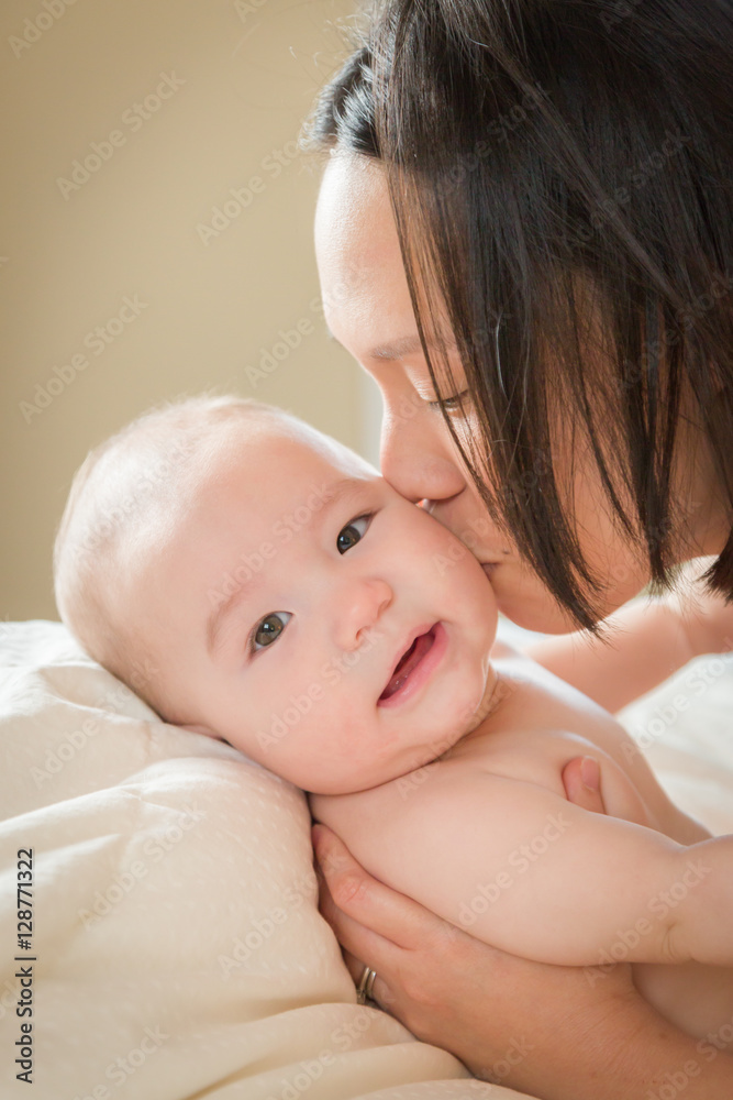Young Mixed Race Chinese and Caucasian Baby Boy Laying In His Bed with His Mother. Young Mixed Race Chinese and Caucasian Baby Boy Laying In His Bed with His Mother.
