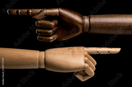 Hands black and white shows opposite directions. Racism. Isolated on black background. Studio shot. Copy space text.