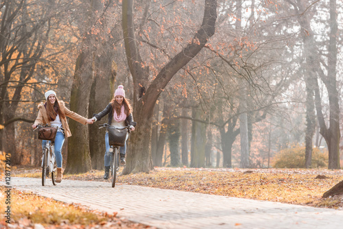 Friends riding bicycles in autumn park