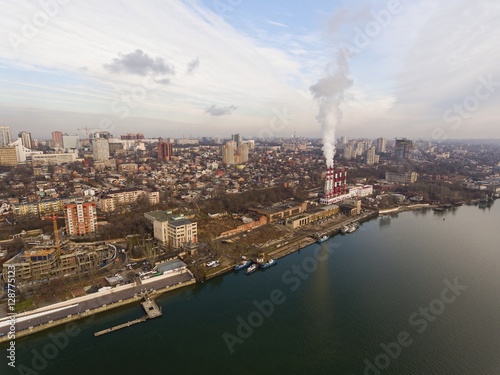 Modern aerial cityscape with a thermal power plant and river. Aerial view. © kolidzei