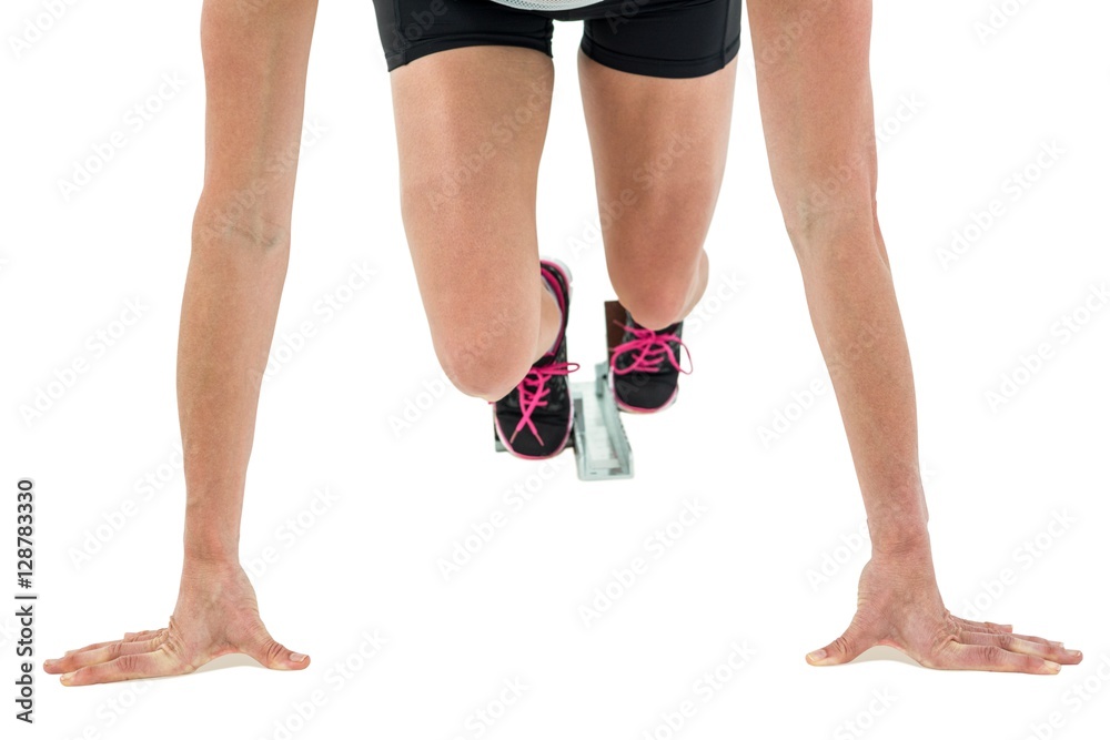 Female athlete in position ready to run