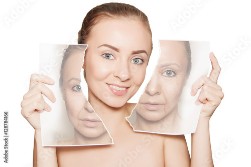 woman breaks photo with her old face and demonstrating pure skin photo