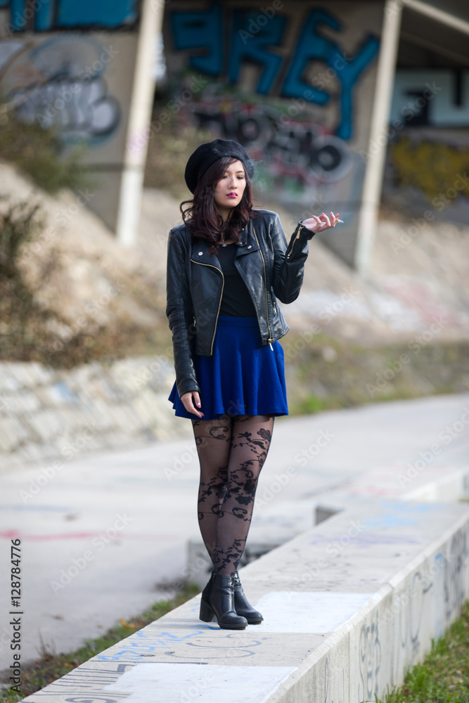 Beautiful Asian girl with cigarette wearing skirt and leather jacket Stock  Photo | Adobe Stock
