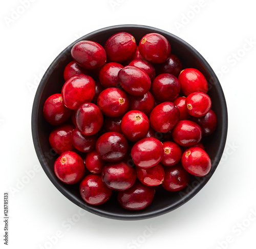 Bowl of cranberries isolated on white, from above