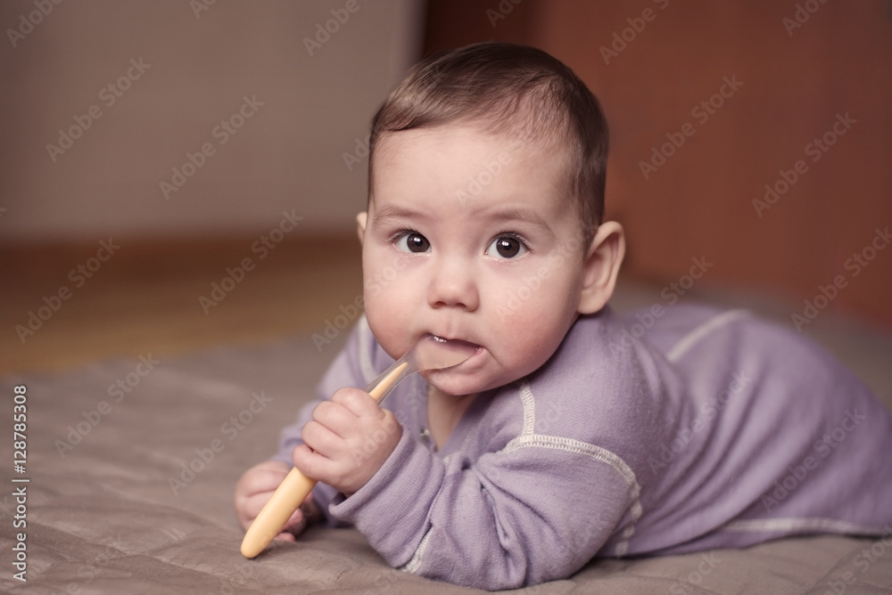 Little boy holding a spoon in his mouth Little boy holding a spoon in his mouth