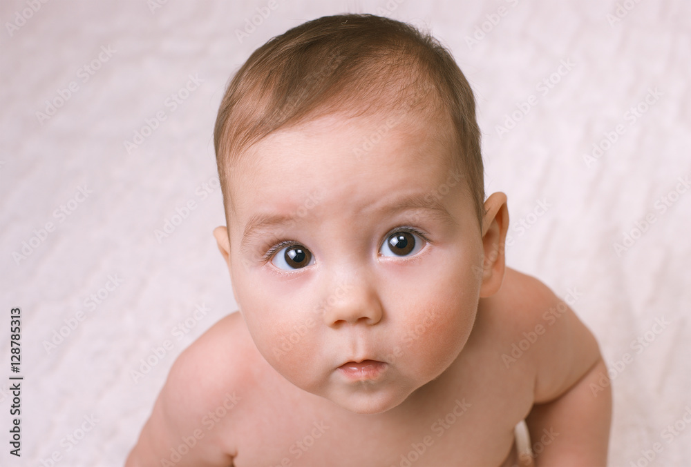Curious little baby looking up at the camera Curious little baby looking up at the camera