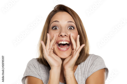 happy woman yelling with hands next to the mouth photo