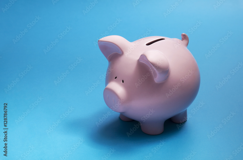 Piggy bank on blue background 