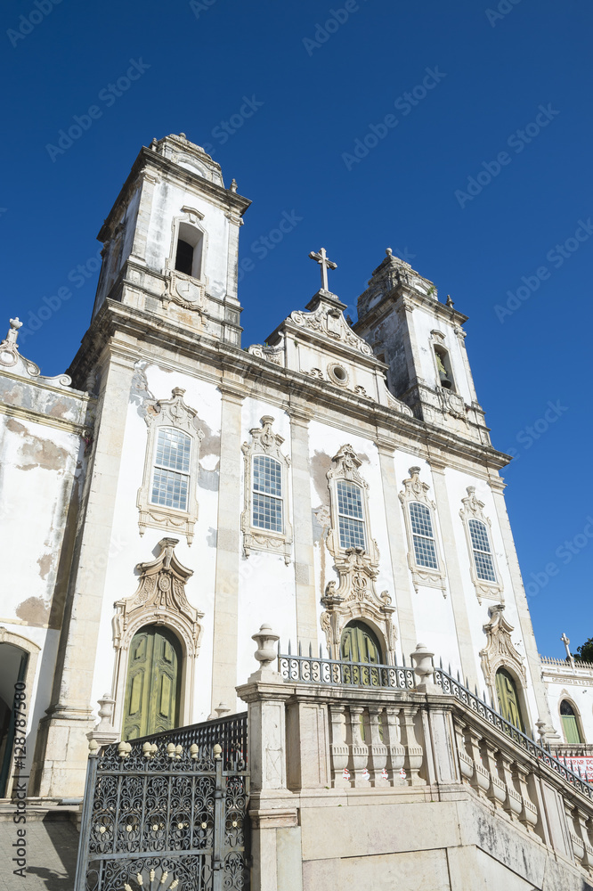 Weathered neoclassical colonial facade of the Ordem Terceira do Carmo church in Salvador, Bahia, Brazil under bright blue sky