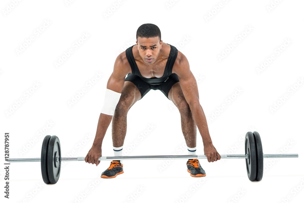 Bodybuilder lifting heavy barbell weights