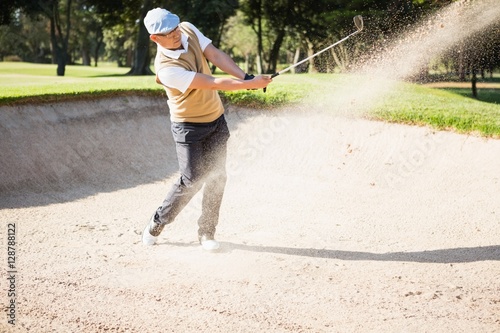 Side view of sportsman playing golf 
