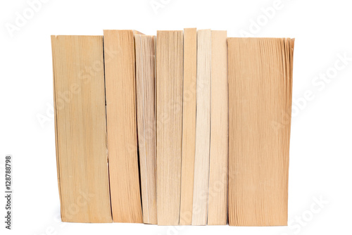 Stack of old paperback books isolated on white background
